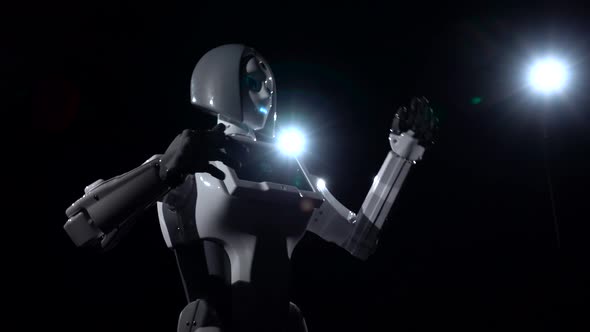 Robot Moves and Gestures with Hands . Black Background