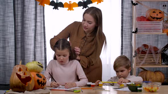 Happy Family in a Room Decorated for Halloween
