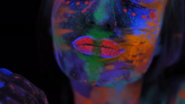 Portrait of a Graceful Model Girl with a UV Pattern on Her Face and Body