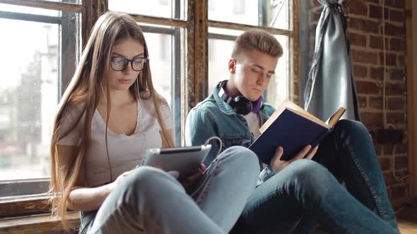 Students Using Tablet and Reading Book