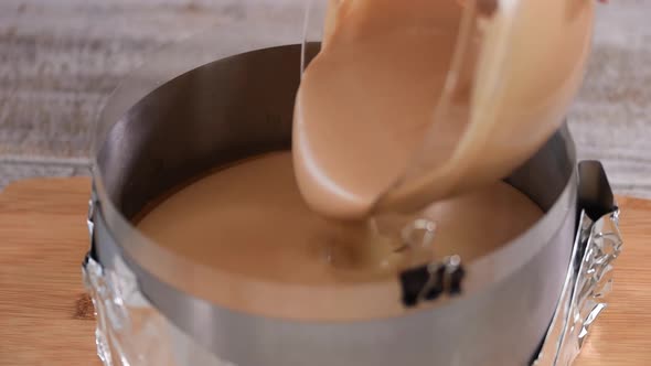 Confectioner Pouring Chocolate Mousse Into A Pastry Ring.