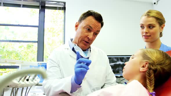 Dentist interacting with young patient