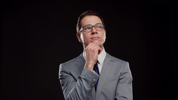 Studio portrait of successful and smart businessman in suit and tie.