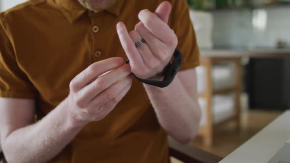 Albino african american man with dreadlocks using smartwatch