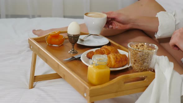 Closeup Shot of Young Woman Drinking Coffee in Cosy Hotel Room in the Morning