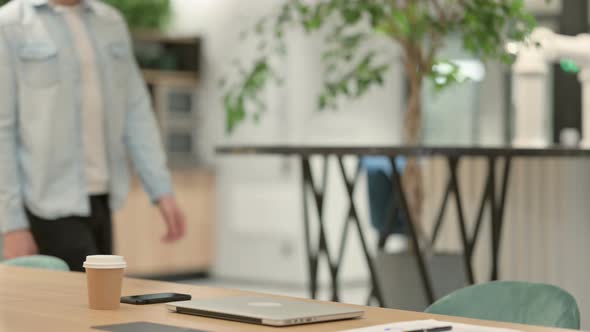 Creative Young Man Coming Back and Opening Laptop