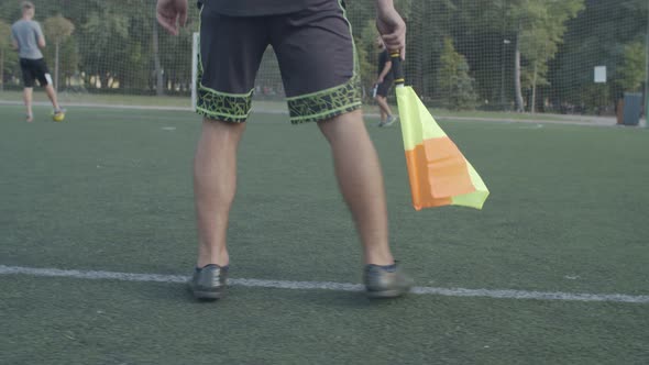 Linesman Moving Along Touchline During Soccer Game