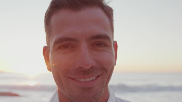 Portrait of young man smiling at the seaside