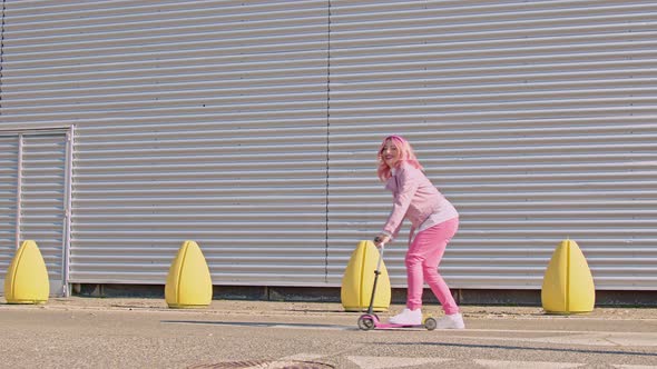 Woman listening music on children's push scooter