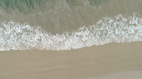 Aerial view drone camera of Beautiful tropical sea sandy beach and waves crashing against sand beach