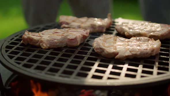 Big Meat Slices Browning on Grate