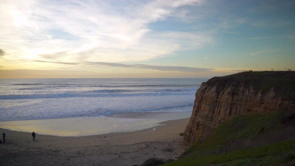 Colorful skies and huge cliff at sunset.