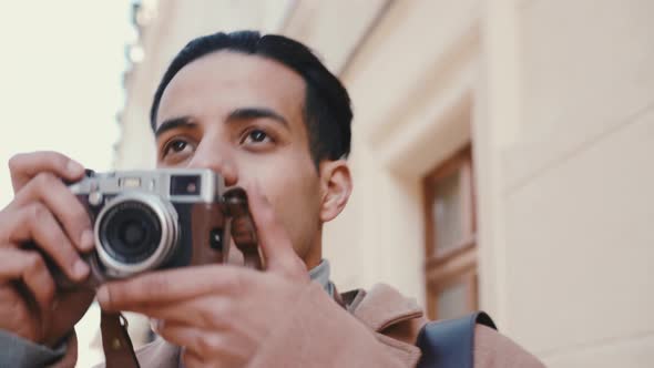 Happy Arabian man walking and taking photos