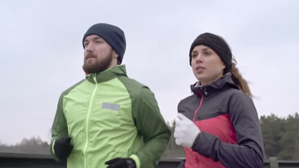 Young Couple Jogging in Cold Weather