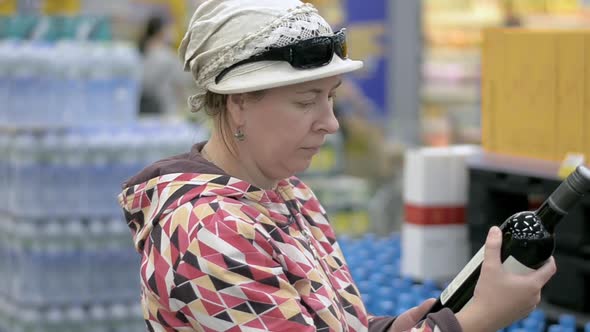 The Lady Chooses the Wine at the Grocery Store.