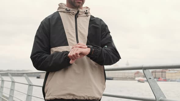 Portrait of Attractive Sporty Man Checking His Smartwatch