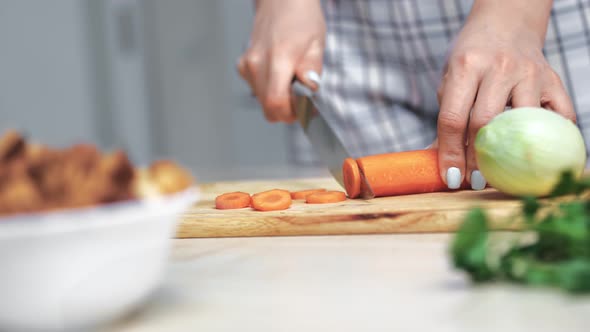 Closeup Female Hands Cutting Carrot Knife on Wooden Board Preparing Dish
