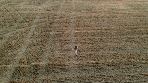 Girl Child in a Dress Runs Through a Mown