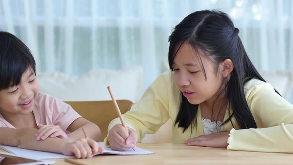 Asian Children Doing Homework Together