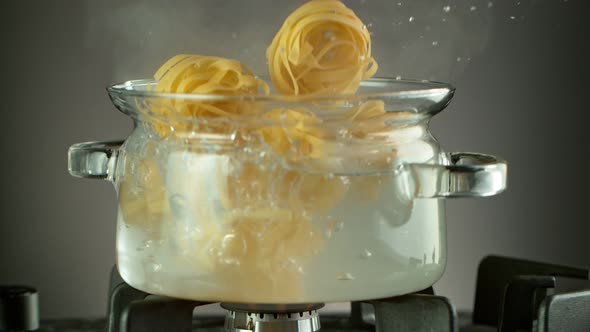 Super Slow Motion Shot of Fresh Pappardelle Falling Into Boiling Salted Water at 1000 Fps