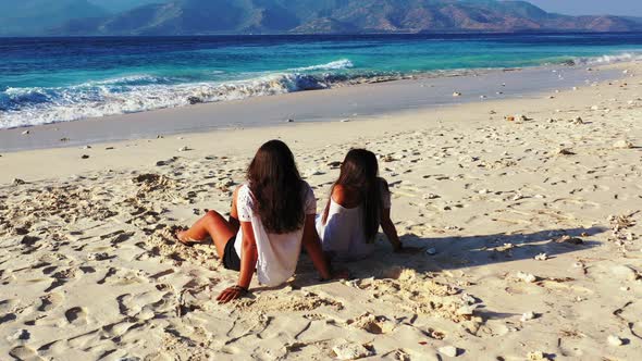 Modern fun women travelling having fun at the beach on paradise white sand and blue 4K background