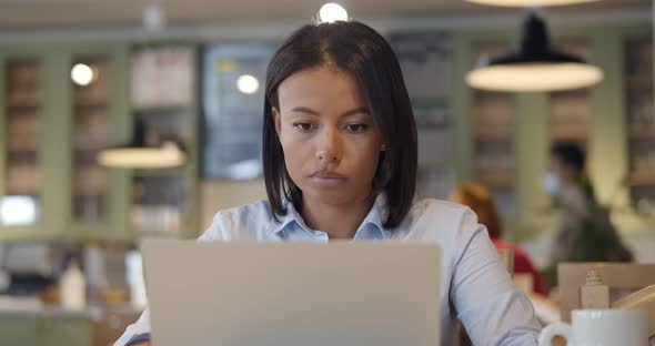 Portrait of Young Beautiful Afro Businesswomen Enjoying Coffee During Work on Laptop in Cafe