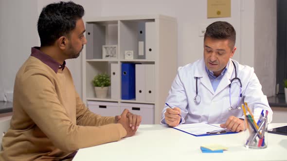 Male Doctor and Patient Talking at Hospital 16