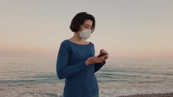 Girl with mask by the ocean