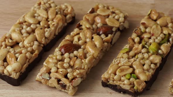 Cereal superfood energy bars with almond nuts, dry fruits, raisins chocolate on the wood table