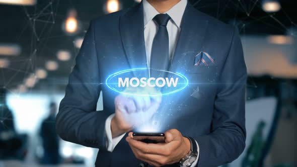 Businessman Smartphone Hologram Word Country   Capital   Moscow