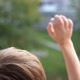 The Child Stands at the Window and Waving His Hands - VideoHive Item for Sale