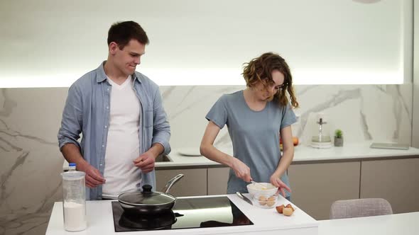 Joyful Couple Cooking Together in Domestic Kitchen