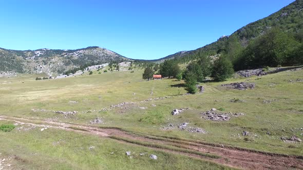 People sitting in front of brick mountain cabin