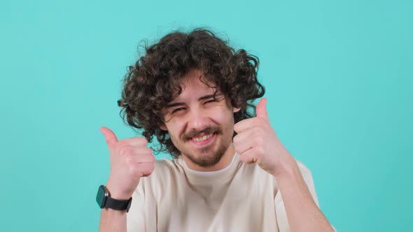 Close Up of a Satisfied Bearded Man with Curly Hair Doing Thumbs Up Gesture