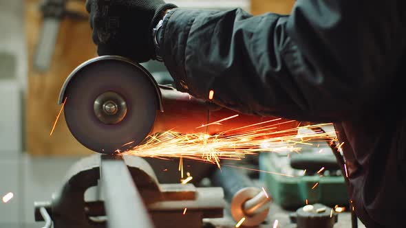 Angle Grinder Cutting Metal at Workshop