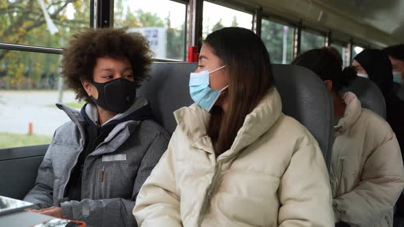 Masked Diverse Pupils Communicating on School Bus