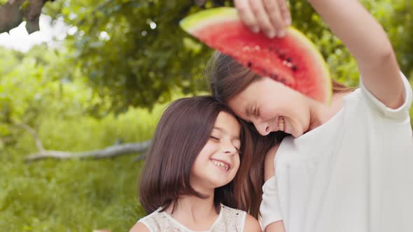 Portrait of Two Cute Girls in Casual Summer Dress Standing Face to Face with