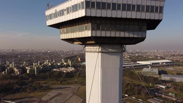 soaring drone shot of the top of Torre Espacial in city park at sunset in Buenos Aires