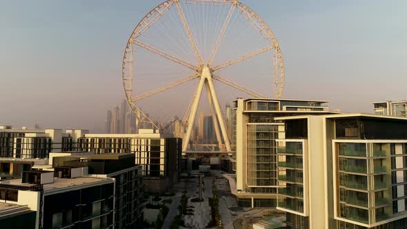 Aerial view passing by of the Ferris wheel under construction, Dubai.