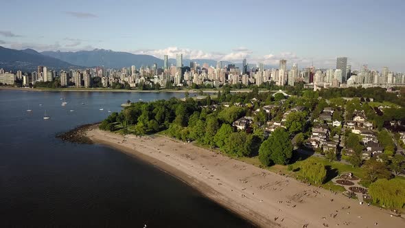 People Social Distancing On The Re-opened Kitsilano Beach. Downtown Skyline, Condos, And English Bay