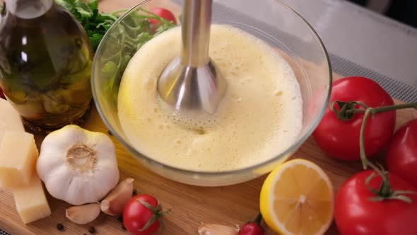 Making Caesar Salad Sauce  Mixing Egg Yolk in Glass Bowl with Blender