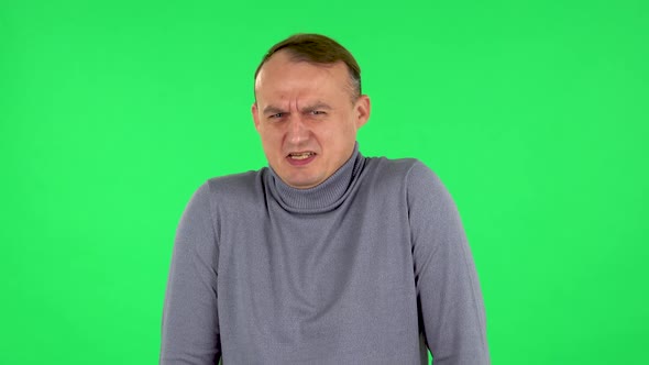 Portrait of Male Is Showing Disgust for Bad Smell or Taste. Green Screen