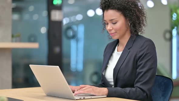 Thumbs Up By African Businesswoman Working on Laptop