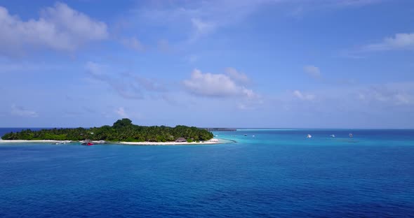 Wide angle above travel shot of a white sandy paradise beach and blue sea background