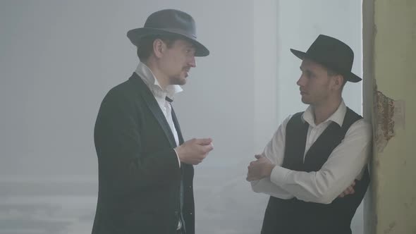 Portrait Two Confident Adult Men in Fedora Hat Standing in the Broken Durty Place and Talking