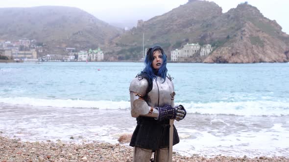 Woman Warrior in Armor Against Fortress on Rock and Sea