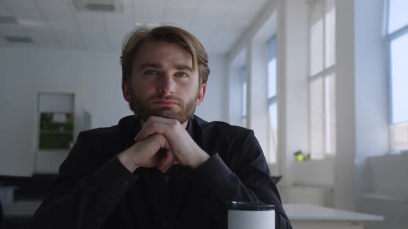 Man Sits and Thinking About His Boring Work