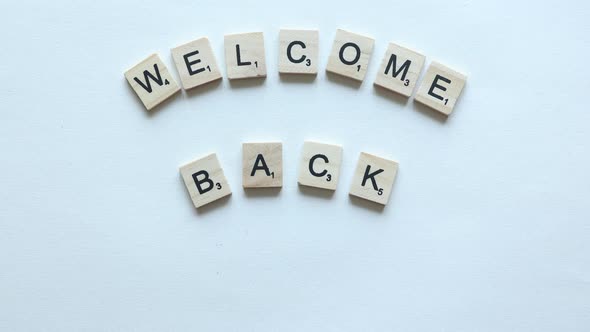 welcome back phrase composed from letters on wooden blocks