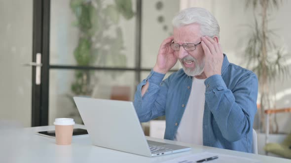 Senior Old Man Having Headache While Using Laptop in Office
