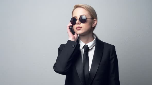 businesswoman in a classic business suit talking on mobile phone